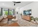Bright living room with wood floors, modern furniture, shiplap accent wall and lots of natural light at 7616 Paradiso Dr, Apollo Beach, FL 33572