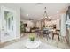 Open-concept living room showcasing dining area, modern lighting, and a comfortable seating arrangement at 7616 Paradiso Dr, Apollo Beach, FL 33572