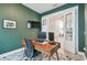 Stylish home office with green walls, a modern desk, and an accent rug with double french doors at 7616 Paradiso Dr, Apollo Beach, FL 33572