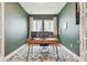 Stylish home office with olive colored walls, a modern desk, and an accent rug at 7616 Paradiso Dr, Apollo Beach, FL 33572