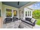 Covered patio with comfortable lounge seating and view of the beautifully landscaped backyard at 7616 Paradiso Dr, Apollo Beach, FL 33572