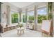 Bright playroom features large windows, built-in storage, and an art easel for creative activities at 7616 Paradiso Dr, Apollo Beach, FL 33572