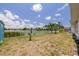 The backyard features a waterfront view, landscaping and a seating area with two chairs and umbrella at 8014 Lotus Dr, Port Richey, FL 34668