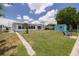 Backyard featuring a shed, seating and lawn with a walkway to the house at 8014 Lotus Dr, Port Richey, FL 34668
