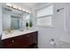 Stylish bathroom with a modern vanity, a framed mirror, and a glass-enclosed shower stall at 8014 Lotus Dr, Port Richey, FL 34668