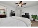 Relaxing bedroom with a ceiling fan, comfortable bed, and stylish dark dresser at 8014 Lotus Dr, Port Richey, FL 34668