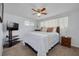 Well-lit bedroom featuring a ceiling fan, two large windows, and a comfortable bed at 8014 Lotus Dr, Port Richey, FL 34668