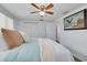 Bedroom featuring a ceiling fan, a large window, a comfortable bed, and neutral carpet at 8014 Lotus Dr, Port Richey, FL 34668