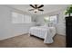 Cozy bedroom featuring a ceiling fan, neutral carpet and a comfortable bed for relaxation at 8014 Lotus Dr, Port Richey, FL 34668
