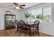 Bright dining room featuring a wooden table set, a display cabinet, and a large picture window at 8014 Lotus Dr, Port Richey, FL 34668