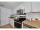 Bright kitchen featuring granite countertops, stainless steel appliances, and ample cabinet space at 8014 Lotus Dr, Port Richey, FL 34668