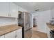Bright kitchen with stainless steel refrigerator and granite countertops, ready for cooking at 8014 Lotus Dr, Port Richey, FL 34668