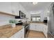 Well-lit kitchen featuring modern appliances, granite countertops, and white cabinetry at 8014 Lotus Dr, Port Richey, FL 34668