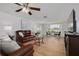 Inviting living room with wood-look flooring, comfortable leather seating, and a scenic window view at 8014 Lotus Dr, Port Richey, FL 34668