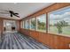 Relaxing sunroom with beautiful lake views, offering style and comfort with blue floors at 8014 Lotus Dr, Port Richey, FL 34668