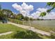 The waterfront features a concrete barrier, lawn and seating to relax by the lake at 8014 Lotus Dr, Port Richey, FL 34668