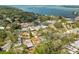 A bird's-eye view highlights a neighborhood with mature trees, with a glimpse of the serene bay at 8335 42Nd N Ave, St Petersburg, FL 33709