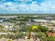 Aerial shot captures the neighborhood, green spaces, lake, and a large retail shopping center nearby at 8335 42Nd N Ave, St Petersburg, FL 33709