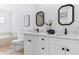 Bright bathroom features double vanity, marble countertops, modern fixtures and decorative floral arrangement at 8335 42Nd N Ave, St Petersburg, FL 33709