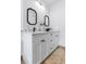 Modern bathroom with white cabinets, marble countertop, and black framed mirrors offers a sleek design at 8335 42Nd N Ave, St Petersburg, FL 33709