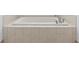 Bathtub in tiled alcove with tile surround offers a clean and relaxing space at 8335 42Nd N Ave, St Petersburg, FL 33709