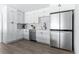 Modern kitchen with white shaker cabinets, stainless steel appliances, and wood grain floors at 8335 42Nd N Ave, St Petersburg, FL 33709