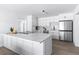 Modern kitchen with white cabinetry, stainless steel appliances, and a large island with quartz countertop at 8335 42Nd N Ave, St Petersburg, FL 33709