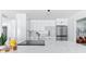 Modern kitchen with white cabinetry, stainless steel appliances, and a large island with quartz countertop at 8335 42Nd N Ave, St Petersburg, FL 33709