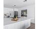 Modern kitchen featuring white cabinets, stainless steel appliances, quartz counters, and wood grain floors at 8335 42Nd N Ave, St Petersburg, FL 33709