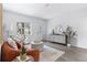 Bright living room featuring wood floors, an orange couch, a round ottoman, and modern decor at 8335 42Nd N Ave, St Petersburg, FL 33709