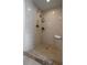 Modern walk-in shower with earth-tone tiles, built-in shelves, and stylish fixtures at 8335 42Nd N Ave, St Petersburg, FL 33709