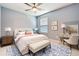 Serene bedroom with a blue accent wall, ceiling fan, and a comfortable bed, providing a tranquil atmosphere at 9806 Bennington Dr, Tampa, FL 33626