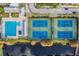 Aerial view of a community swimming pool, bathhouse, and tennis courts next to a pond at 9806 Bennington Dr, Tampa, FL 33626