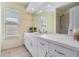 Neutral bathroom with a large vanity with double sinks and views from the large window at 9806 Bennington Dr, Tampa, FL 33626