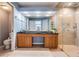 Bright bathroom with a double vanity, granite counters, a walk-in shower, and tiled floors at 9806 Bennington Dr, Tampa, FL 33626