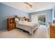 Bright bedroom with a large bed, built-in headboard shelving, and sliding glass doors to the pool at 9806 Bennington Dr, Tampa, FL 33626