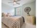 Cozy bedroom with light green walls, a ceiling fan, and natural light through a window at 9806 Bennington Dr, Tampa, FL 33626