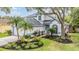 Inviting two-story home with a well-maintained lawn, mature trees and an attached two-car garage at 9806 Bennington Dr, Tampa, FL 33626