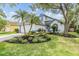 Charming home with a well-manicured front lawn, lush landscaping and lovely curb appeal at 9806 Bennington Dr, Tampa, FL 33626