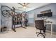 Unique home gym and office space with a weight rack, multiple bikes, and dual monitors at 9806 Bennington Dr, Tampa, FL 33626