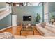 Spacious living room with gleaming hardwood floors, contemporary decor, and a view of the staircase at 9806 Bennington Dr, Tampa, FL 33626
