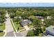 Aerial view of a charming home nestled in a lush, tree-lined neighborhood with a manicured lawn at 1 Mandarin Ter, Safety Harbor, FL 34695