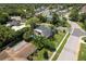 An aerial view reveals a backyard oasis with a sparkling pool and lush landscaping at 1 Mandarin Ter, Safety Harbor, FL 34695