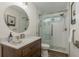 Bathroom featuring modern fixtures, a tiled shower, and a stylish vanity at 1 Mandarin Ter, Safety Harbor, FL 34695