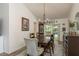 Charming dining room with wood table, chandelier, and sliding doors to the inviting outdoor space at 1 Mandarin Ter, Safety Harbor, FL 34695