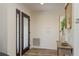 Inviting foyer with a decorative glass door, wood-look flooring, and a stylish console table with modern decor at 1 Mandarin Ter, Safety Harbor, FL 34695