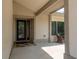 Welcoming front porch with stylish tile flooring, a glass-paneled front door, and cozy outdoor seating at 1 Mandarin Ter, Safety Harbor, FL 34695