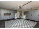 Well-organized garage with ample storage cabinets and modern gray and black flooring at 1 Mandarin Ter, Safety Harbor, FL 34695
