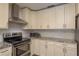 Beautiful kitchen featuring white cabinets, granite countertops, and stainless steel appliances at 1 Mandarin Ter, Safety Harbor, FL 34695