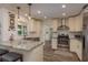 Well-lit kitchen featuring stainless steel appliances, white cabinets, and a stylish tile backsplash at 1 Mandarin Ter, Safety Harbor, FL 34695